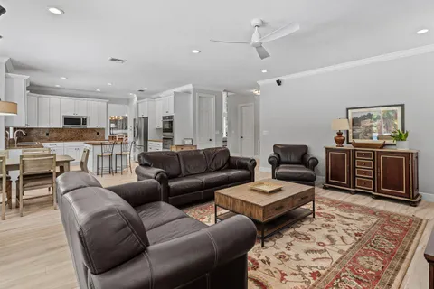a living room with furniture and view of kitchen