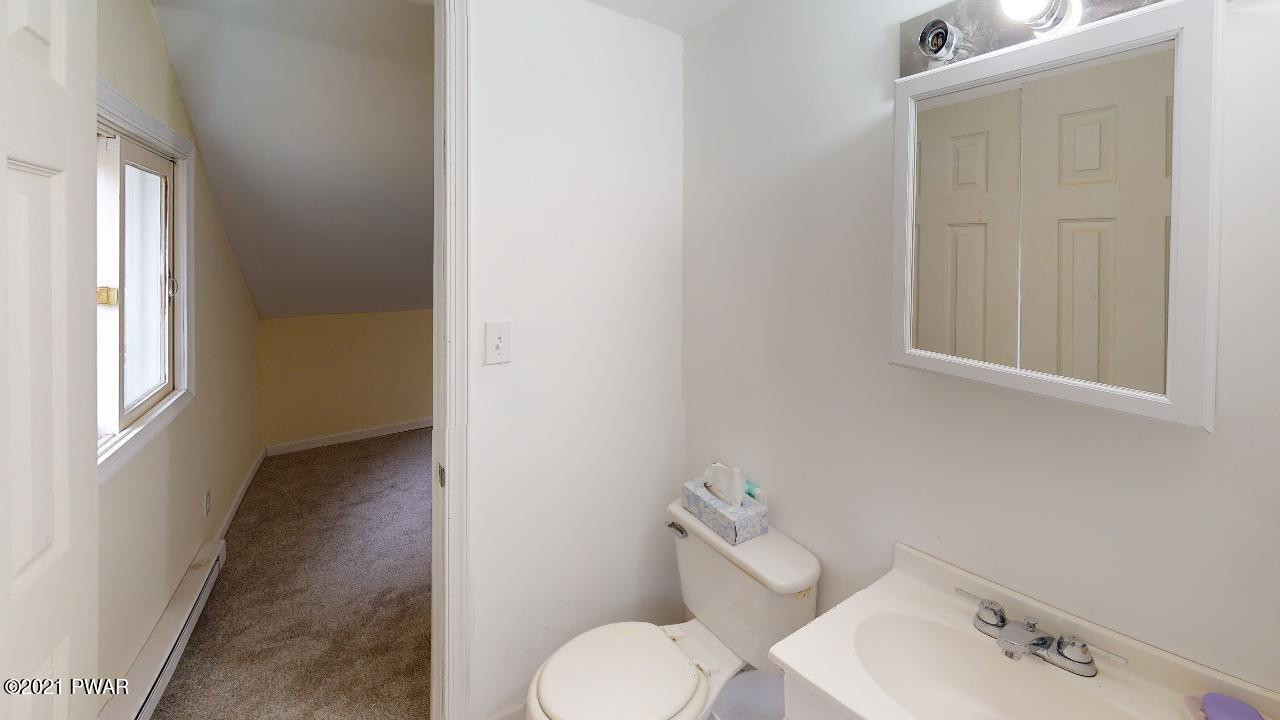 64 Boulder Road Lake Ariel, PA 18436 - Photo 23 of 59 a bathroom with a toilet sink and mirror