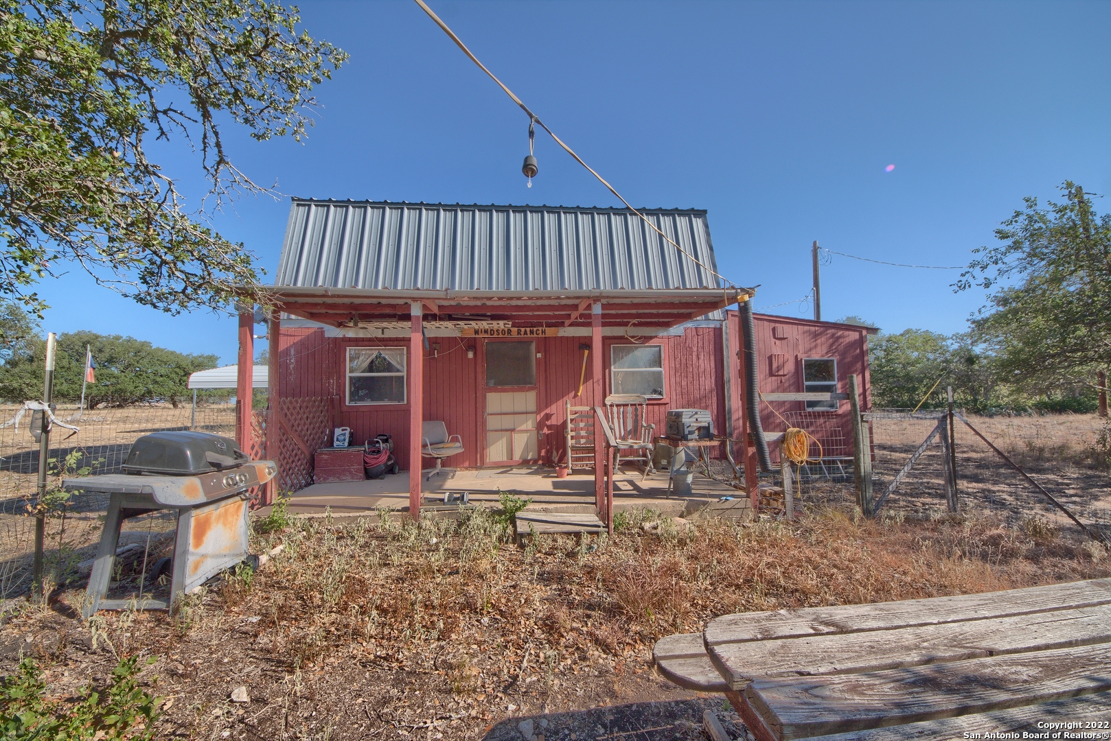 465 Watkins Road Mountain Home, TX 78058 - Photo 15 of 56 a view of a house with backyard porch and sitting area