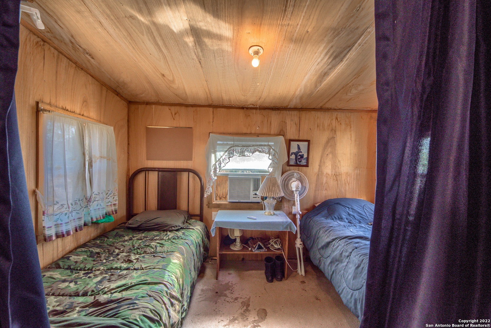 465 Watkins Road Mountain Home, TX 78058 - Photo 25 of 56 a bedroom with furniture and a window