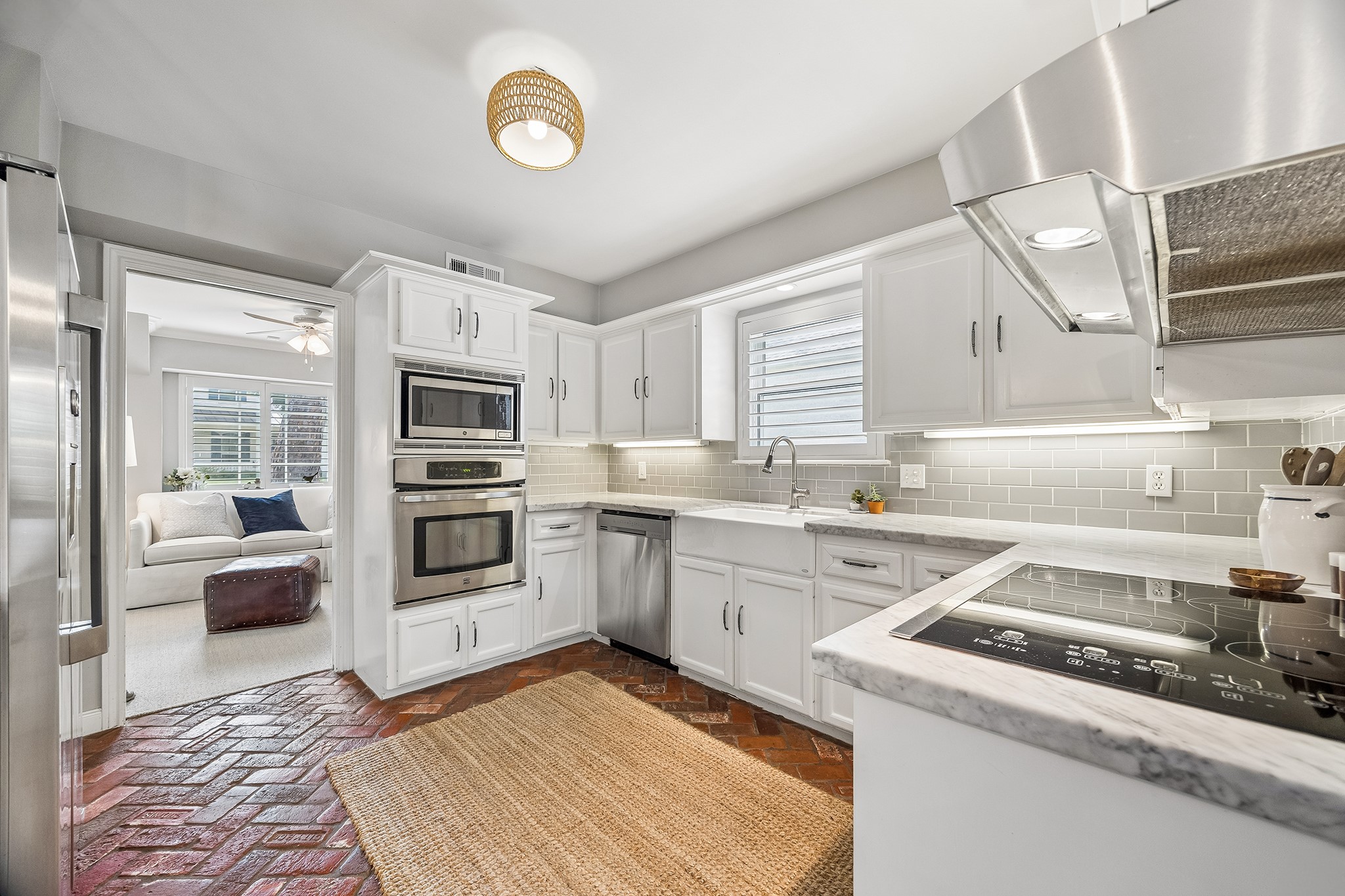 12615 Taylorcrest Road Houston, TX 77024 - Photo 9 of 29 Red brick floors accentuate the carrera marble in this kitchen.
