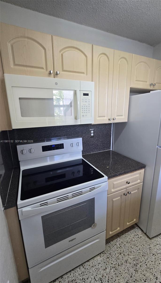 142 Southwest 18th Avenue, Unit 30 Miami, FL 33135 - Photo 11 of 11 a kitchen with a stove and white cabinets