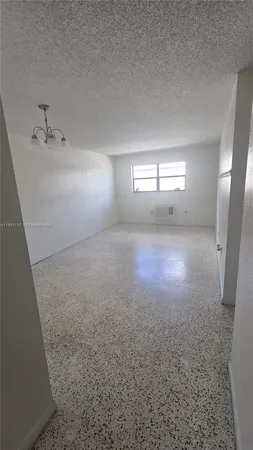 an empty room with a empty space and windows