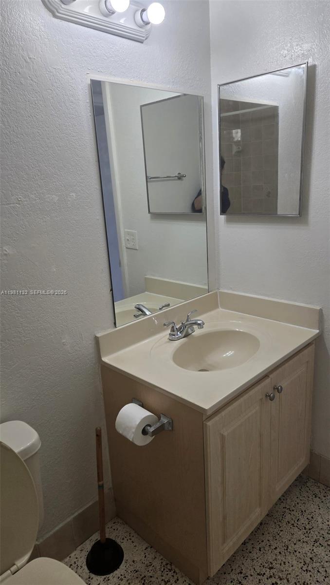 142 Southwest 18th Avenue, Unit 30 Miami, FL 33135 - Photo 5 of 11 a bathroom with a sink toilet and mirror