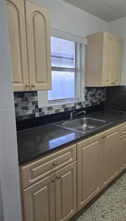a close view of sink and cabinets