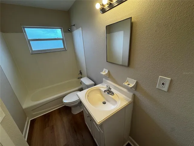 a bathroom with a sink a toilet and mirror
