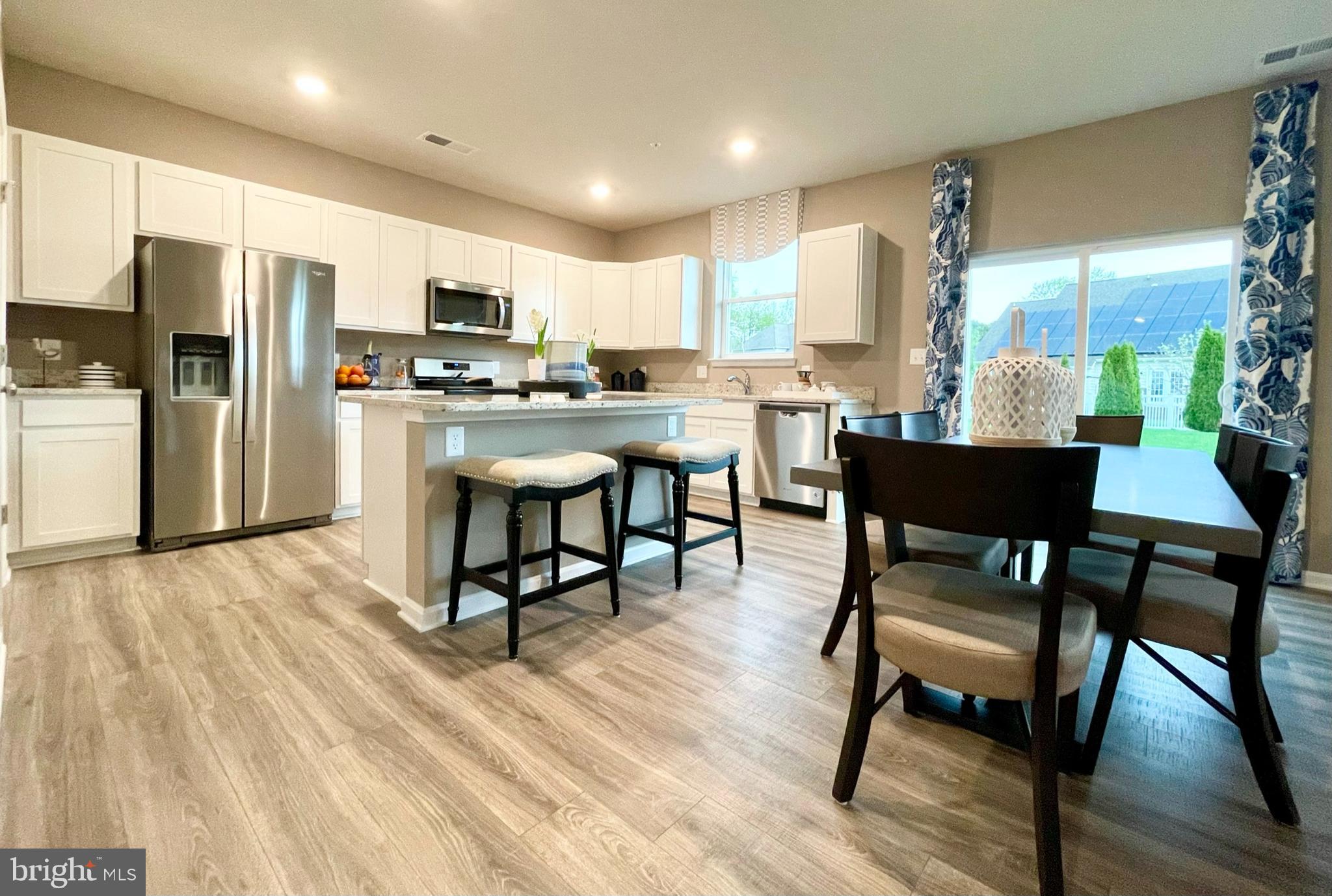 22 Country Living Road Elkton, MD 21921 - Photo 12 of 49 a kitchen with stainless steel appliances a dining table chairs refrigerator and sink