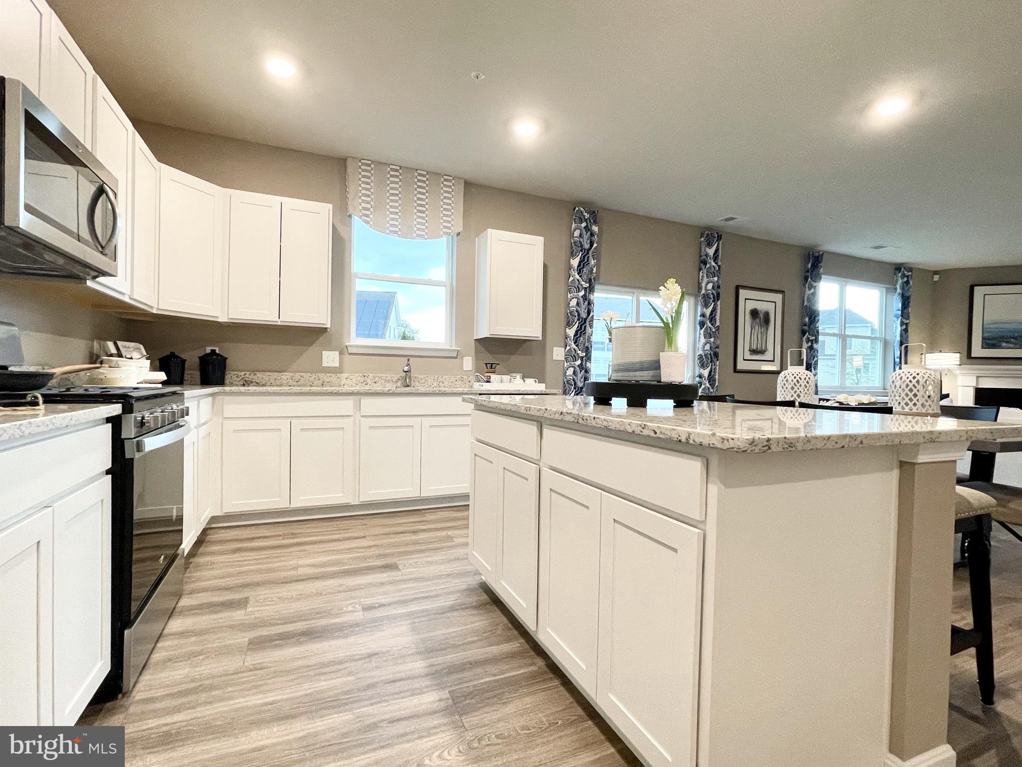 22 Country Living Road Elkton, MD 21921 - Photo 18 of 49 a kitchen with granite countertop white cabinets and white appliances