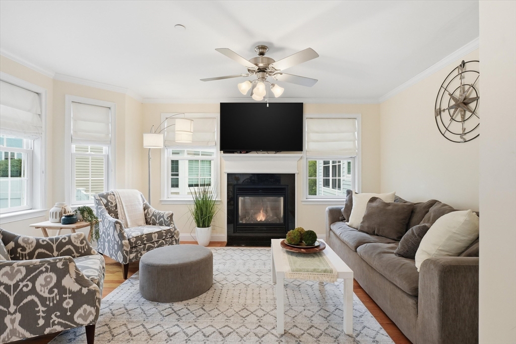 2 B Gates Lane, Unit B Wakefield, MA 01880 - Photo 11 of 42 a living room with furniture a flat screen tv and a fireplace