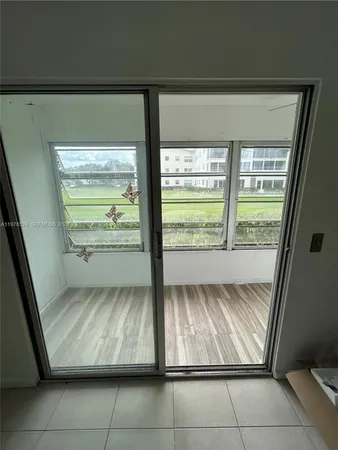 a view of room with window and refrigerator