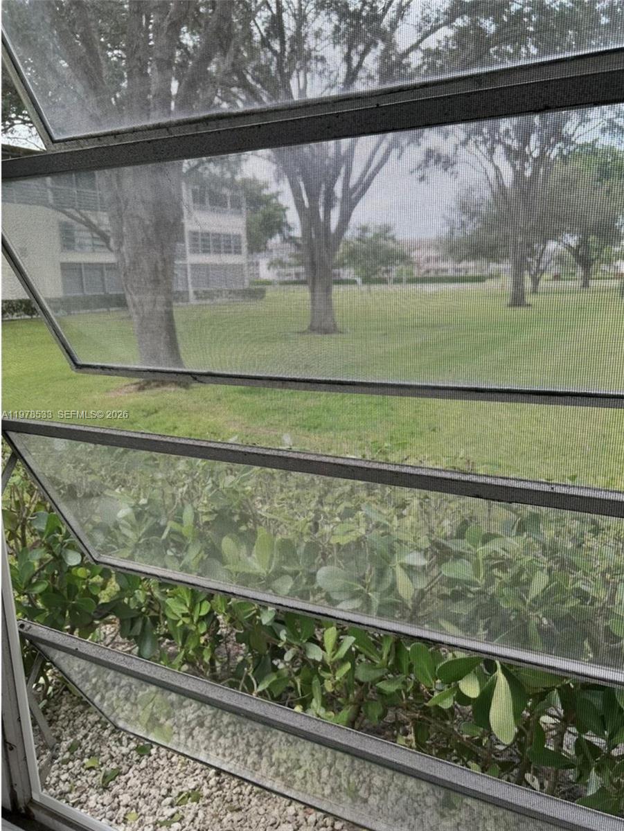 550 Mansfield M, Unit 550 Boca Raton, FL 33434 - Photo 13 of 30 a view of a wooden fence from a window