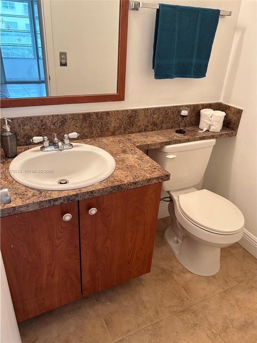 550 Mansfield M, Unit 550 Boca Raton, FL 33434 - Photo 23 of 30 a bathroom with a sink a toilet and mirror
