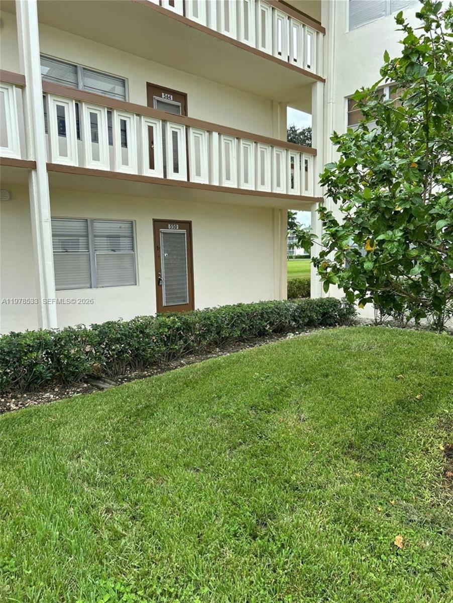 550 Mansfield M, Unit 550 Boca Raton, FL 33434 - Photo 3 of 30 a front view of a house with a yard