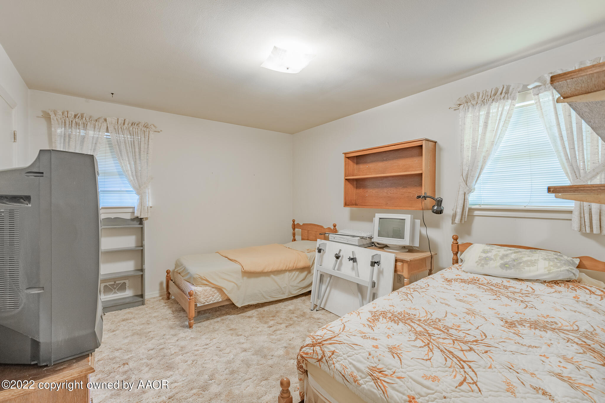 6013 Calumet Road Amarillo, TX 79106 - Photo 14 of 26 a bedroom with a bed and windows