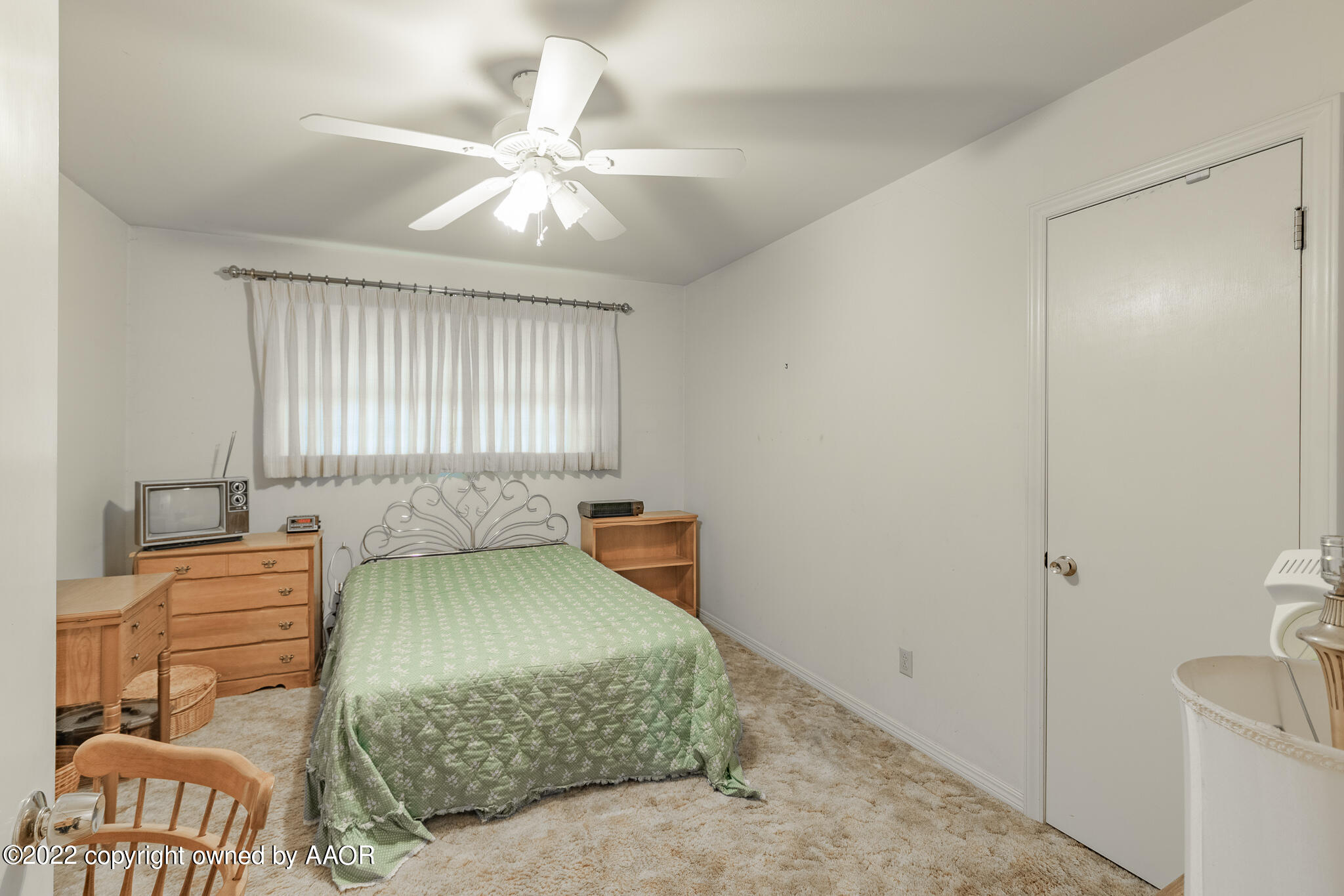 6013 Calumet Road Amarillo, TX 79106 - Photo 16 of 26 a bedroom with a bed and a chandelier