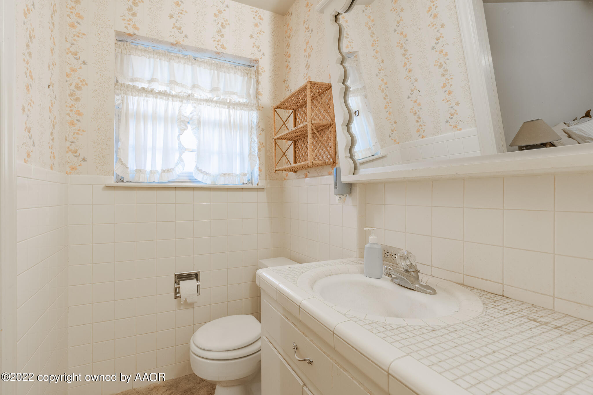 6013 Calumet Road Amarillo, TX 79106 - Photo 19 of 26 a bathroom with a granite countertop sink and a toilet