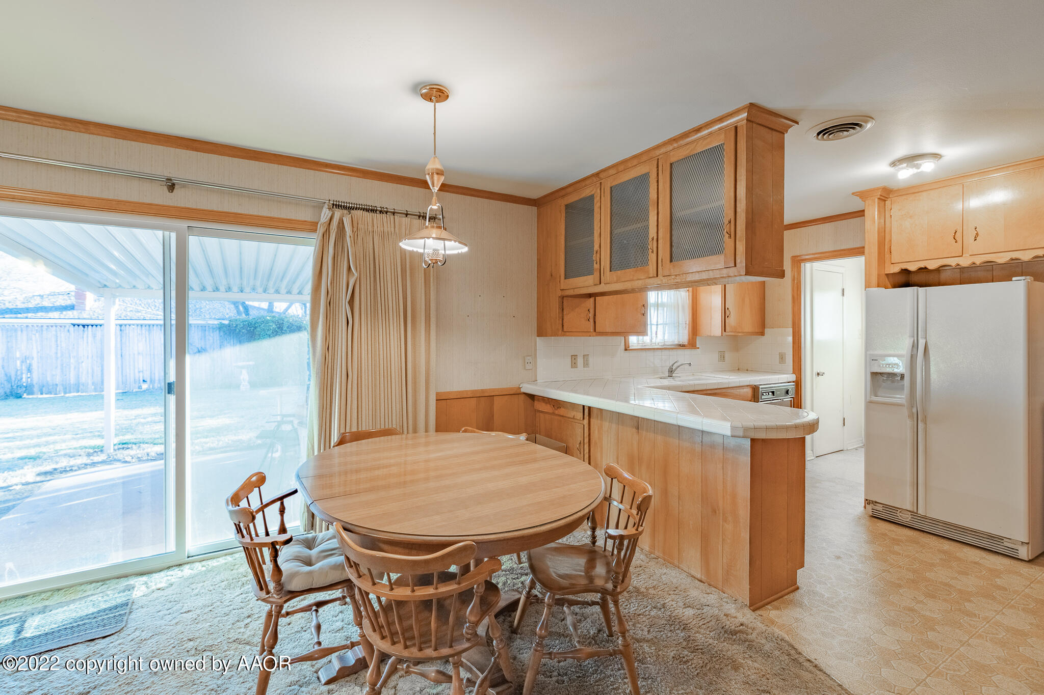 6013 Calumet Road Amarillo, TX 79106 - Photo 9 of 26 a kitchen with stainless steel appliances granite countertop a table chairs stove and refrigerator