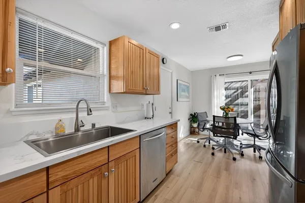 a kitchen with sink cabinets and dining table