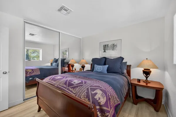 a bed room with a bed and a lamp