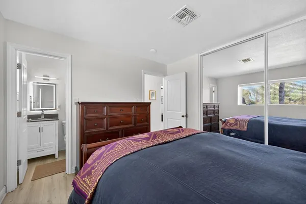 a bedroom with a bed and a closet