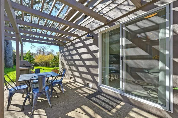 a view of a patio with table and chairs with wooden floor and plants
