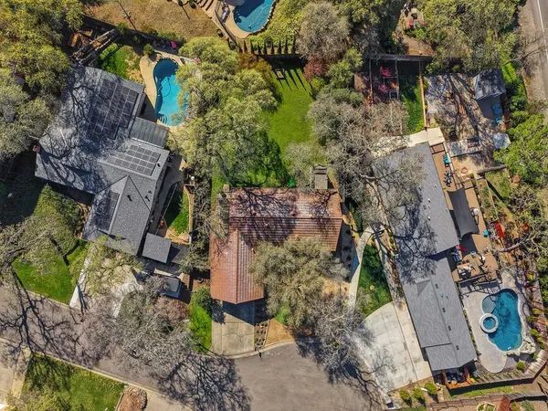 an aerial view of a house with a yard