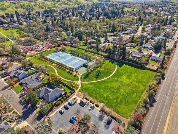 an aerial view of a residential houses with outdoor space