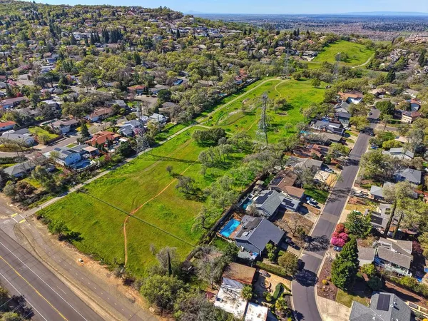 an aerial view of a residential houses with outdoor space