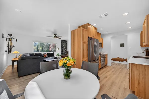 a dining room with furniture a chandelier and kitchen view