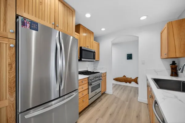 a kitchen with stainless steel appliances a refrigerator stove and sink