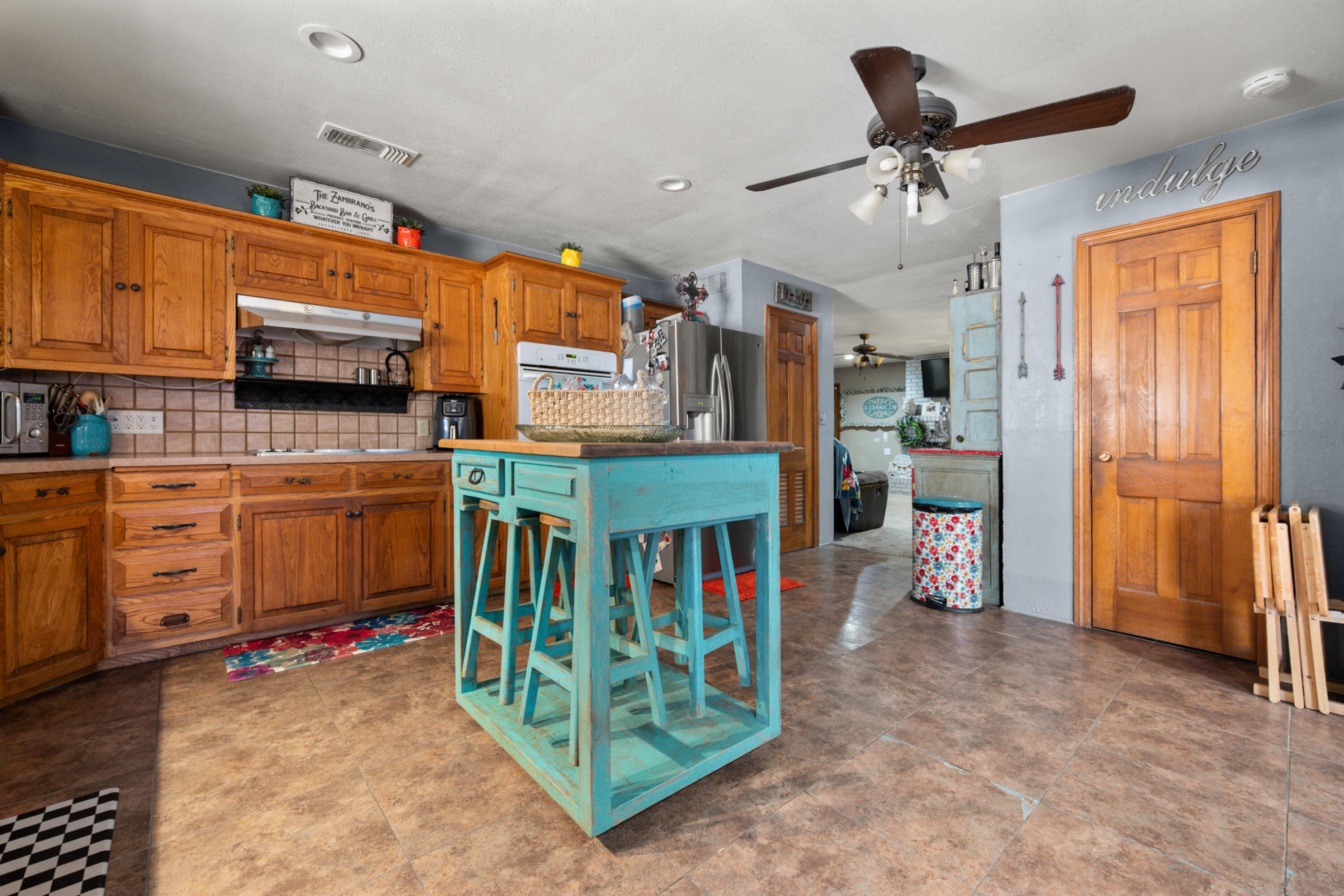 1204 Garland Plainview, TX 79072 - Photo 14 of 29 a kitchen with stainless steel appliances kitchen island granite countertop a table and a refrigerator
