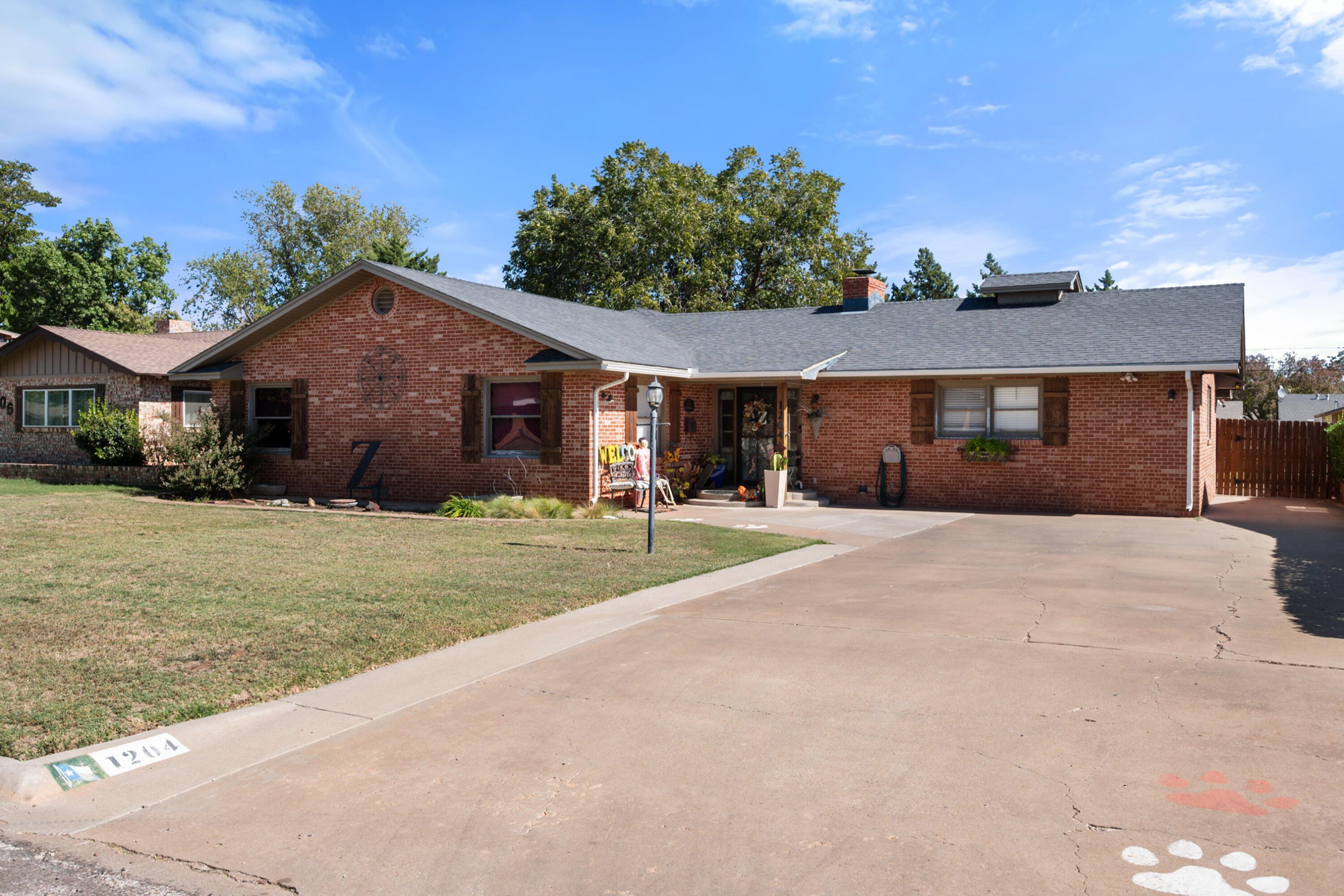 1204 Garland Plainview, TX 79072 - Photo 4 of 29 a front view of a house with a yard and potted plants