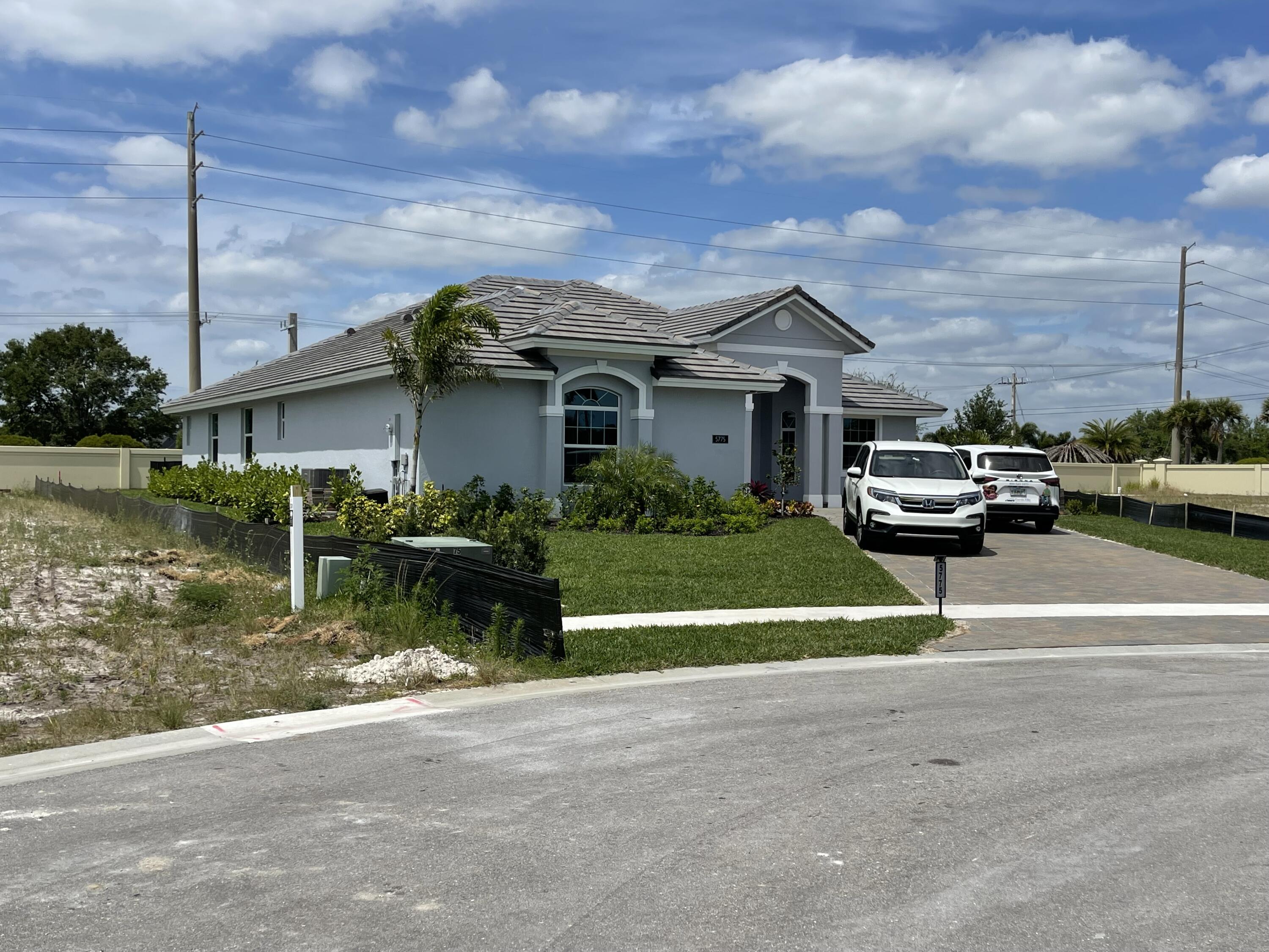 5775 Bent Pine Square Vero Beach, FL 32967 - Photo 1 of 1 a view of a house with a cars park next to a road