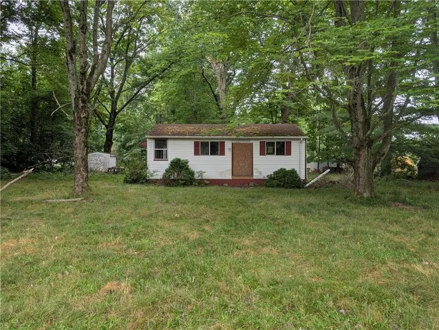 a front view of house with yard and green space