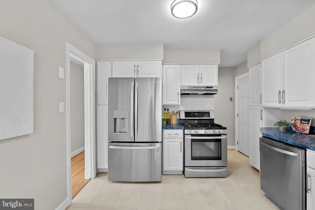 a kitchen with cabinets and stainless steel appliances