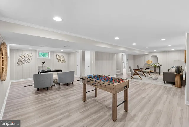 a living room with furniture a window and wooden floor