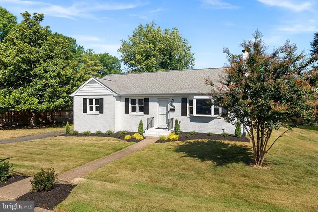 a house view with a sitting space and garden