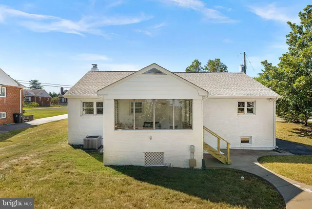 a view of a house with a yard patio and fire pit
