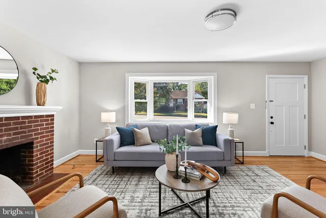 a living room with furniture fireplace and window