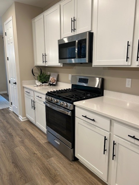 304 Hickory Pointe Drive Dickson, TN 37055 - Photo 11 of 26 a kitchen with stainless steel appliances granite countertop a stove a microwave and a white cabinets
