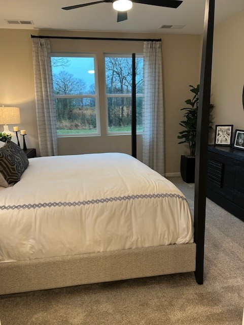 304 Hickory Pointe Drive Dickson, TN 37055 - Photo 21 of 26 a bed sitting in a bedroom next to a window