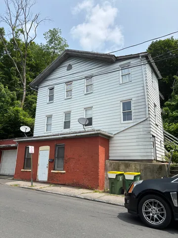 a view of a car parked front of a house