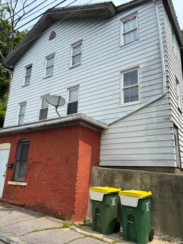 a view of a house with a window and sitting area