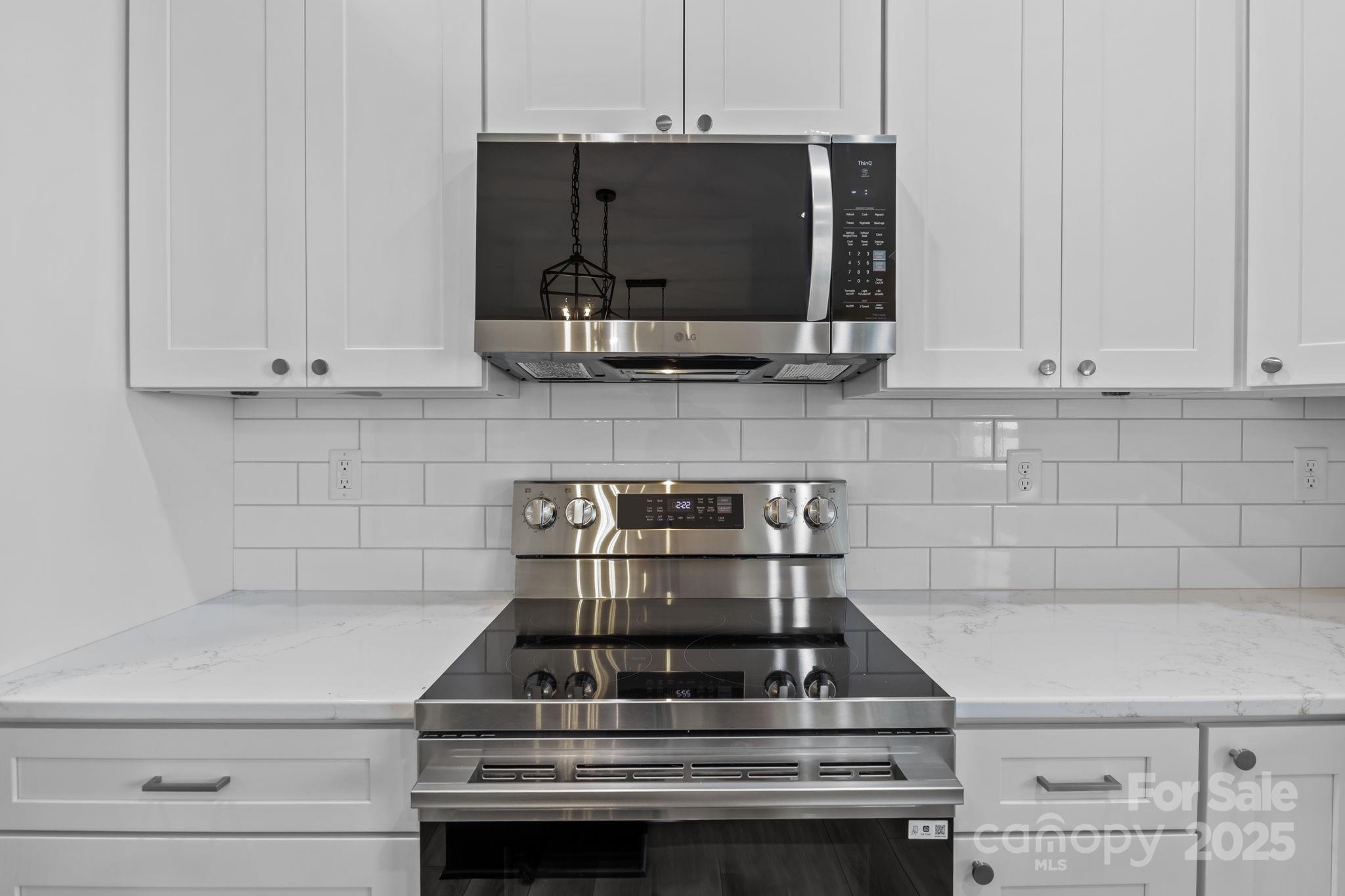 1716 Jennings Road Olin, NC 28660 - Photo 19 of 48 a kitchen with stove top oven and cabinets