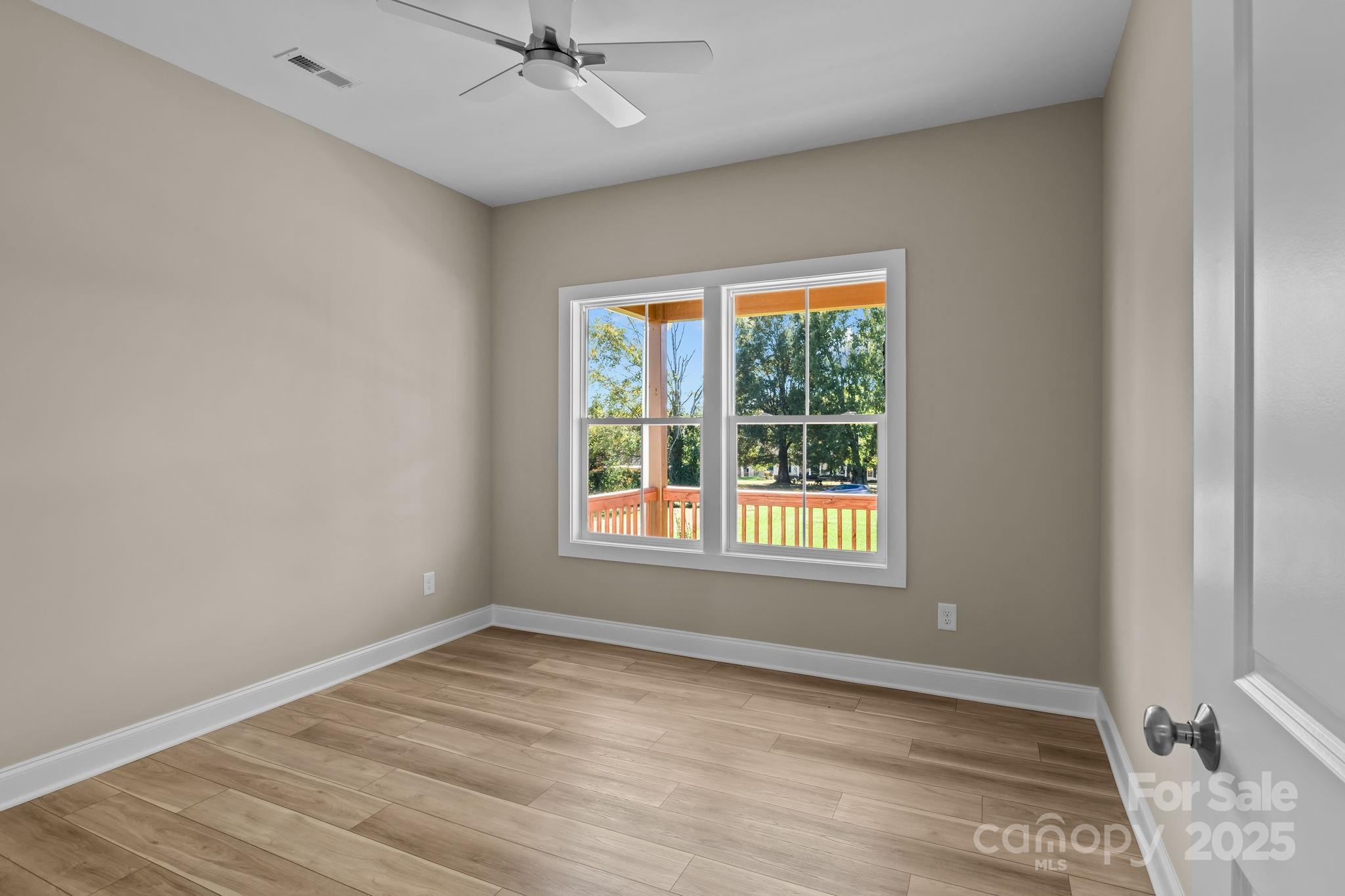 1716 Jennings Road Olin, NC 28660 - Photo 23 of 48 a view of an empty room with wooden floor and a window