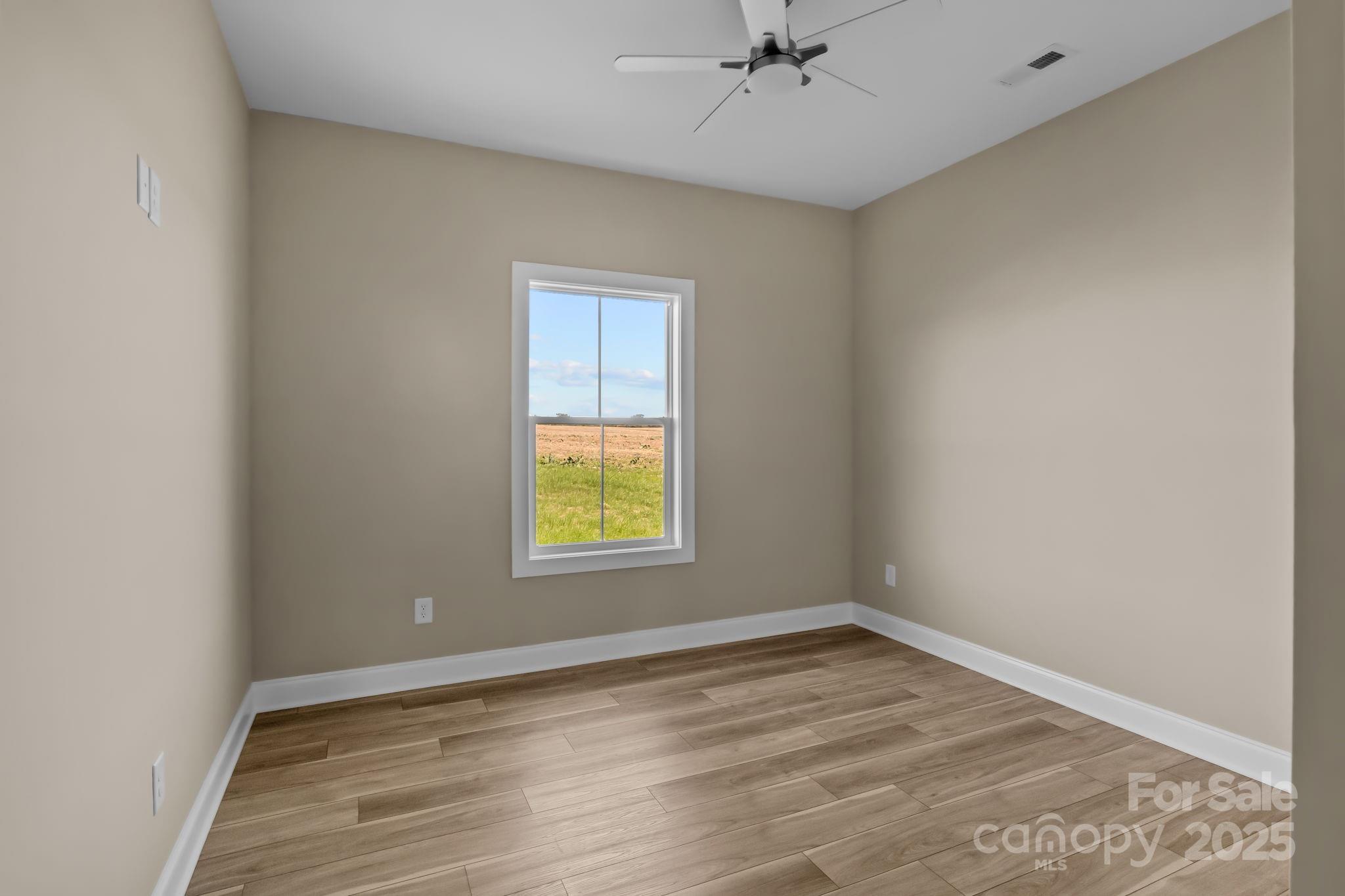 1716 Jennings Road Olin, NC 28660 - Photo 25 of 48 an empty room with a window and wooden floor