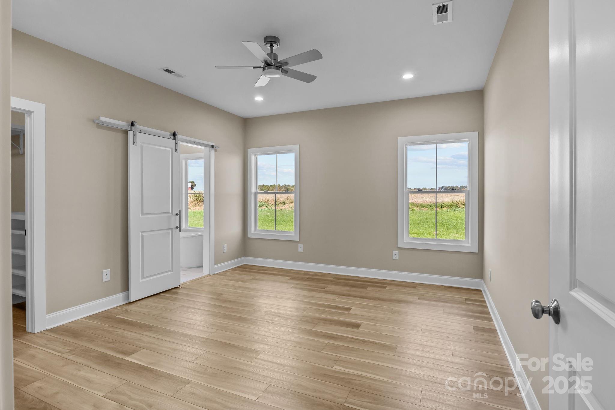 1716 Jennings Road Olin, NC 28660 - Photo 29 of 48 a view of an empty room with window and wooden floor