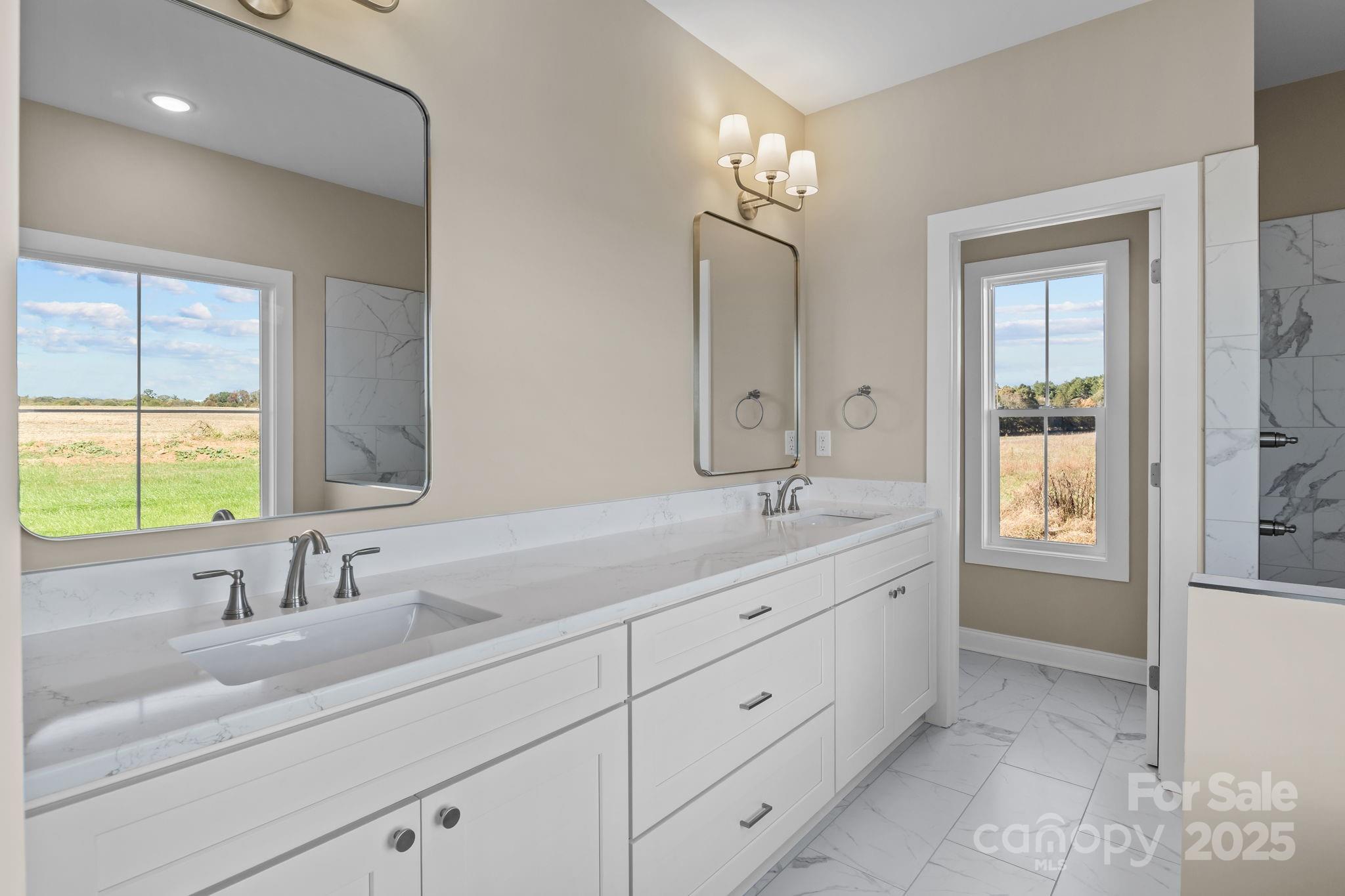 1716 Jennings Road Olin, NC 28660 - Photo 32 of 48 a bathroom with 2 sink tub and a mirror