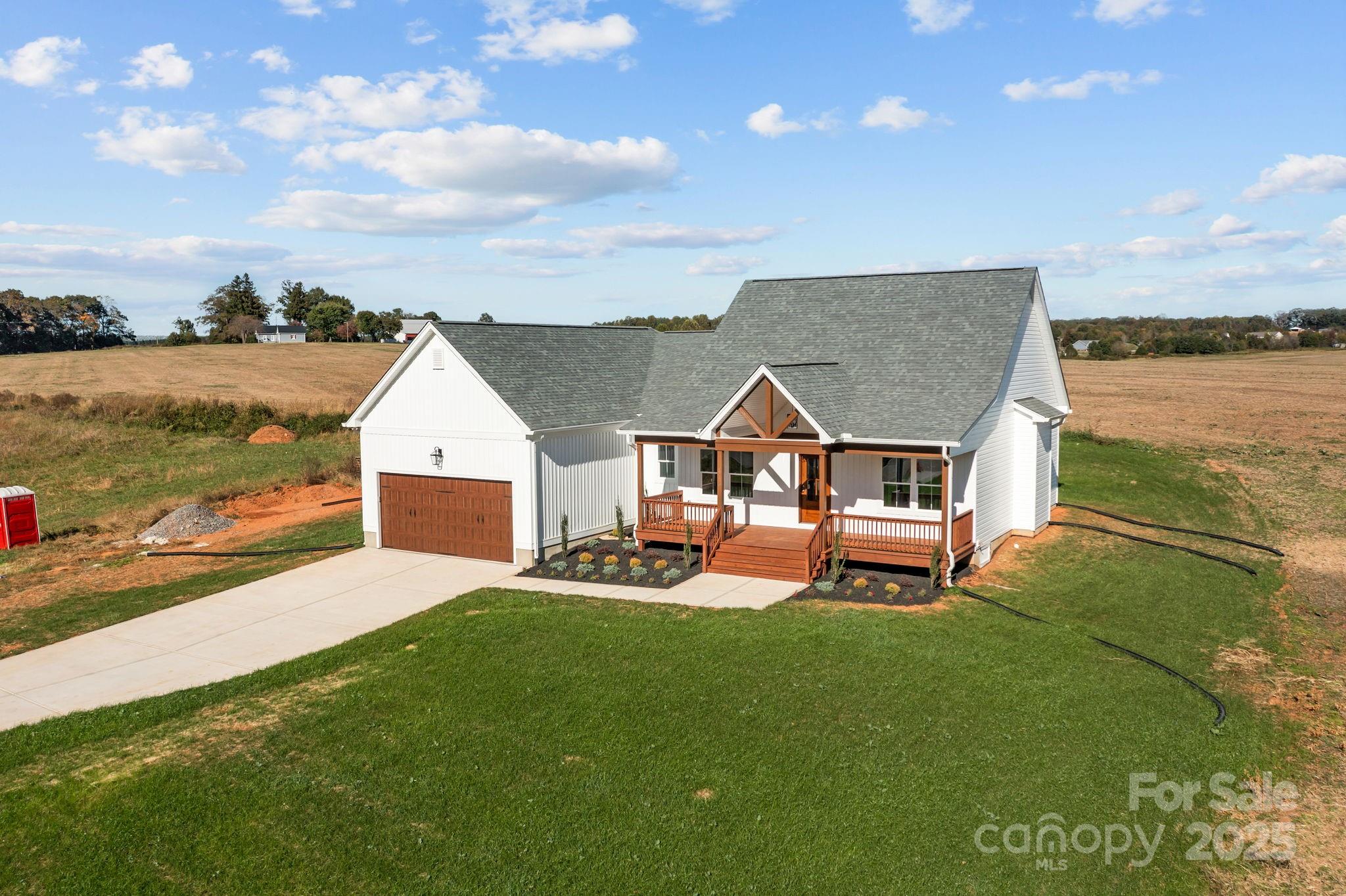 1716 Jennings Road Olin, NC 28660 - Photo 5 of 48 an aerial view of a house with porch and a yard