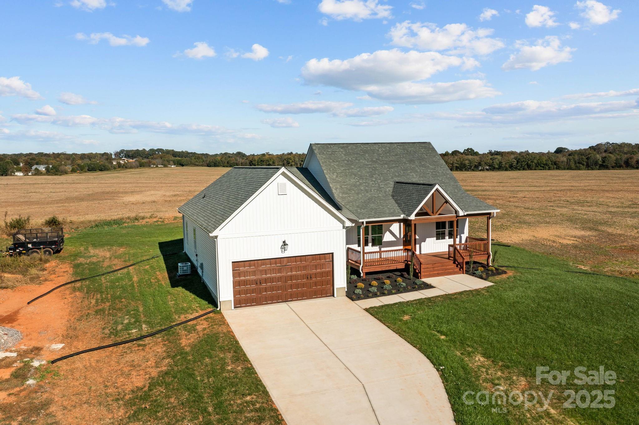 1716 Jennings Road Olin, NC 28660 - Photo 7 of 48 a view of a lake with couches and wooden floor